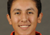 Hispanic young man in a red shirt.