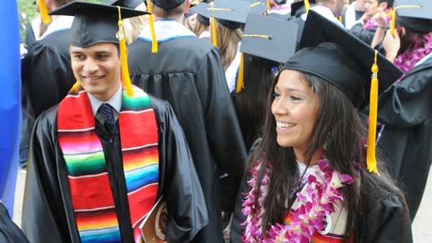 two Hispanic students in cap and gowns during the 2009 commencement ceremonies.