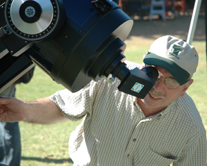 Man looks into a large telescope