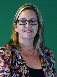 Blond haired woman wearing a flowered blouse.