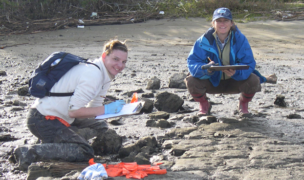 student and faculty member look over an oyster bed in Newport Beach
