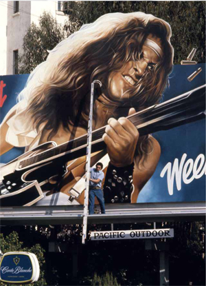 Ted Nugent playing his guitar as represented on a LA billboard.