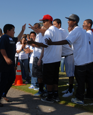 a special athlete receives the congratulations from a group of high school volunteers.