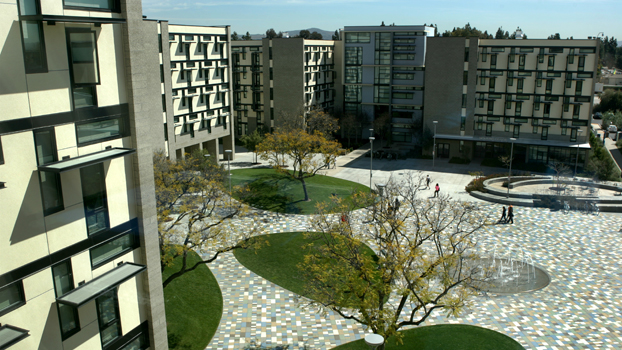 Overhead photo of buildings and students arriving at student housing for move-in day.