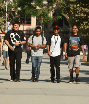 four male students walking from the Titan Student Union.