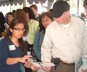 a graduate student goes over material wth a parent during Welcome to Cal State Fullerton Day.