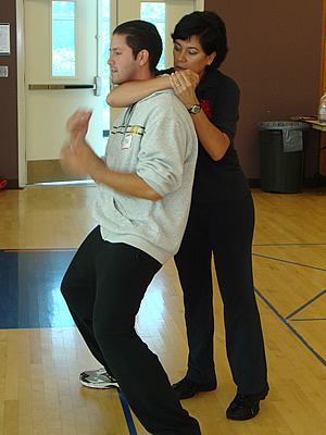Two police officers demonstrate a move in the Rape Aggression Defense course.