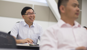 Dajin Yu smiles during discussion on teaching.