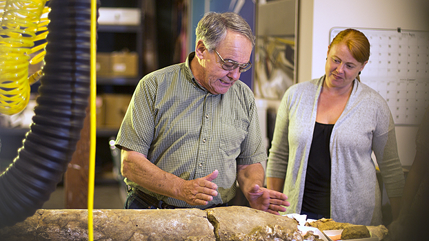 Jere Lipps with Jeannine Pedersen look at a fossil in the Cooper Center.