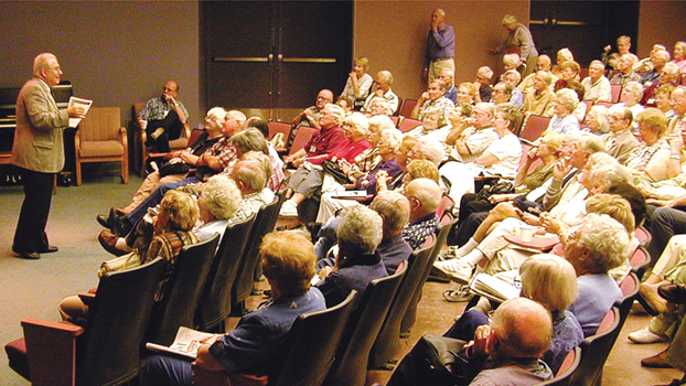 Older gentleman gives lecture in auditorium