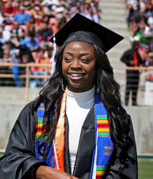 black woman in cap and gown during commencement
