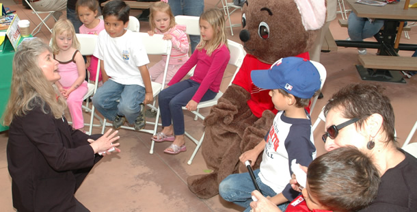 Children gathered together, listening to stories told by event leaders.