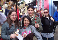 Doreen and her companions holding up sugar-glazed fruit kebabs