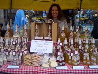 A vendor displays her handmade wares at a fair booth