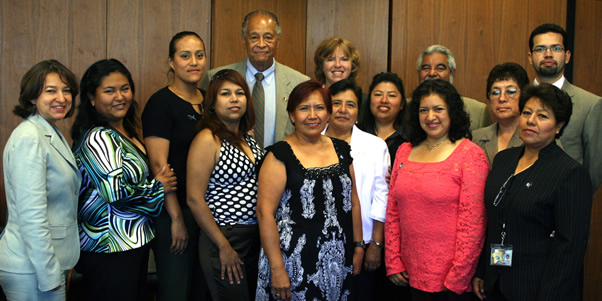 Campus faculty and staff from the program pose with President Milton A. Gordon for a group photo.