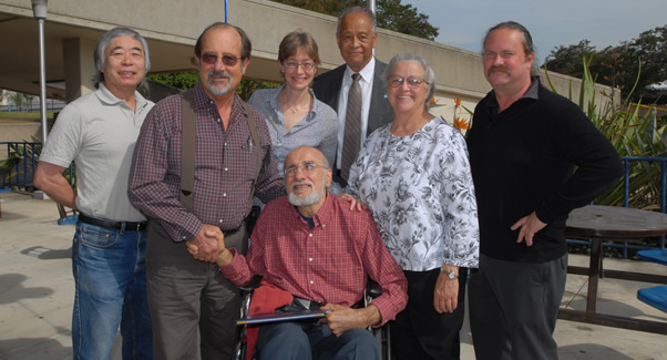 Albert Flores poses with colleagues after receiving his award.