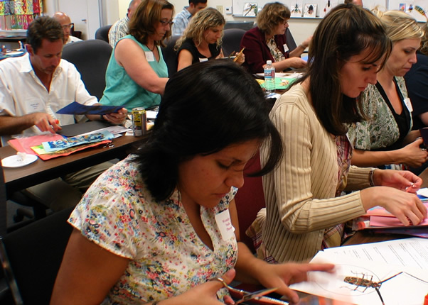 Teachers working with mixed media to create art as part of a training program.