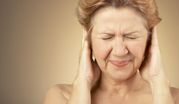Stock photo of a woman holding her head in pain