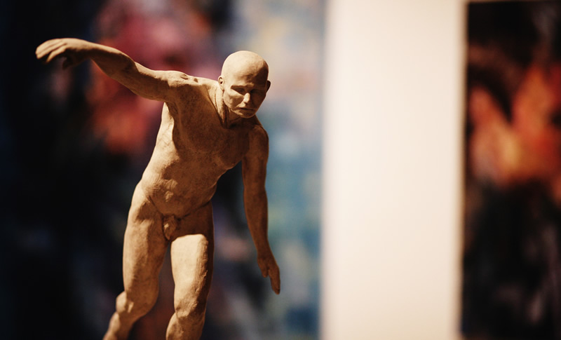 A sculpture of a naked man on display at the Grand Central Art Center