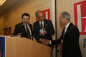 CSUF President Gordon accepting the award from members of HACU
