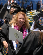 An excited graduate celebrates with a friend