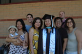 A graduate poses with her family after commencement