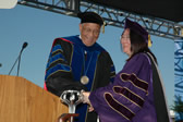 President Milton A. Gordon congratulates Outstanding Professor Stella Ting-Toomey at the commencement ceremony