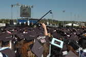 A sea of students in black caps and gowns