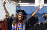 An excited graduate holds cheers