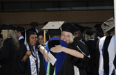 Excited graduates embrace after the ceremonies