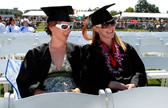 Two grdauates relax during the ceremonies