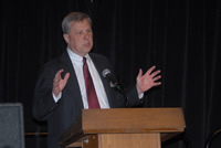 John Burkhart speaking at a podium