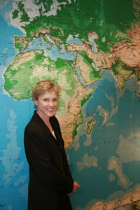 Katrin Harich standing in front of a large world map