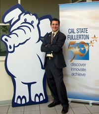 Peter Martinez, communications '08, poses with a standup of Tuffy the titan