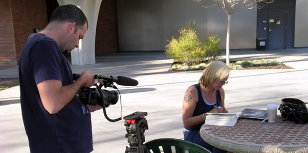 Denise Maupin and cameraman Daniel Hopps work together to film a segment on an upcoming television program.