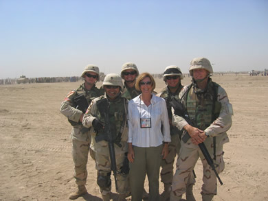 Eileen Padberg with American soldiers at a landfill.