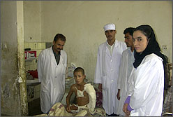 Medical workers attending a wounded boy.