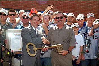 Coach George Horton accepts the key to the city of Fullerton from Mayor Mike Clescieri.