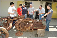 Engineering students restoring a vintage tractor