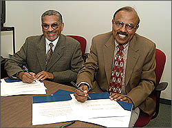 Selase Williams, dean of the College of Arts and Sciences at CSU Dominguez Hills, left, and Raman Unnikrishnan, dean of Fullerton’s College of Engineering and Computer Science