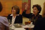 Cindy Stout of the Orange County Teachers Federal Credit Union, and Nannette McBeth of Merrill Lynch, animatedly engage fellow committee members at the Blue Ribbon meeting.