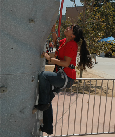 Gabriela Navanjo, a biological science major, tries her hand on climbing the rock wall Thursday, Aug. 23. The rock wall was part of Rec Fest, a health and fitness information fair sponsored by Associated Students Inc. and held in various areas around the Titan Student Union. 